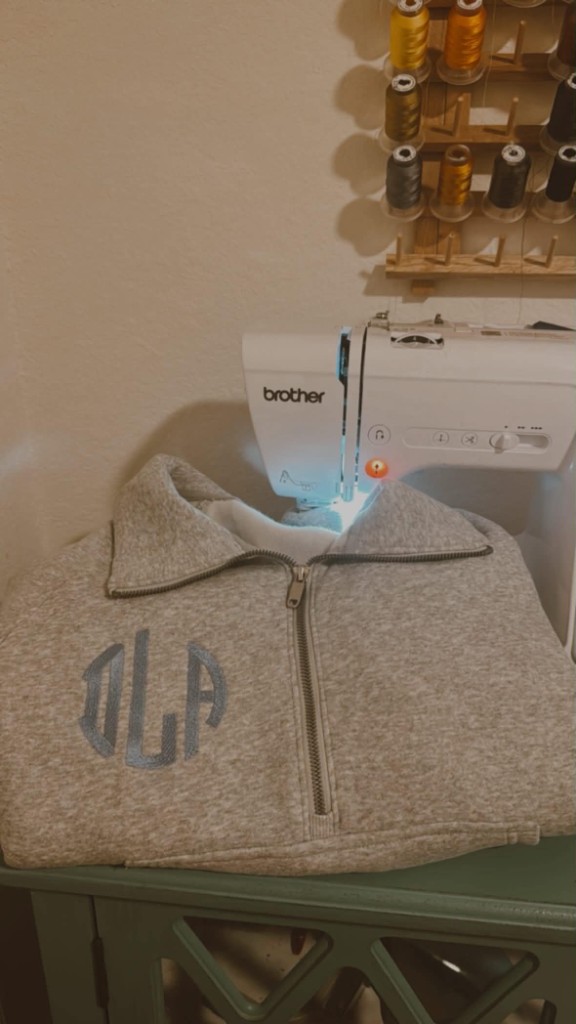 Grey quarter-zip fleece with circular monogram embroidery