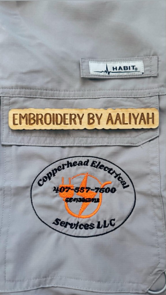 Grey work shirt with embroidered Copperhead Electrical Services LLC logo